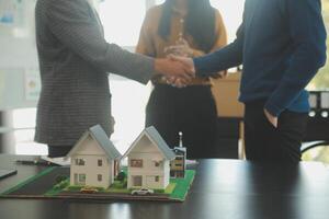 Team of architectures and businessmen discussing and brainstorming on floor plan modification for real estate investment and housing development project photo