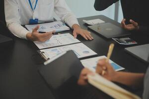 Business team collaboration discussing working analyzing with financial data and marketing growth report graph in team, presentation and brainstorming to strategy planning making profit of company. photo