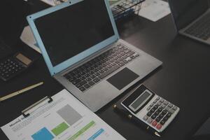 Laptop on a desk in an open financial office. photo