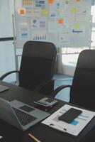 Laptop on a desk in an open financial office. photo