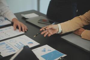 Business team collaboration discussing working analyzing with financial data and marketing growth report graph in team, presentation and brainstorming to strategy planning making profit of company. photo