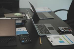 Laptop on a desk in an open financial office. photo
