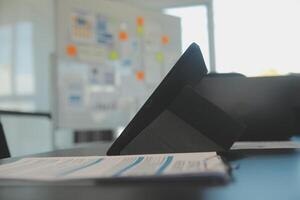 Laptop on a desk in an open financial office. photo