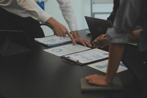 Business team collaboration discussing working analyzing with financial data and marketing growth report graph in team, presentation and brainstorming to strategy planning making profit of company. photo