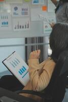 Business team collaboration discussing working analyzing with financial data and marketing growth report graph in team, presentation and brainstorming to strategy planning making profit of company. photo