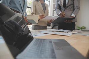 Finance manager meeting discussing company growth project success financial statistics, professional investor working start up project for strategy plan with document, laptop and digital tablet. photo