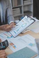 Finance manager meeting discussing company growth project success financial statistics, professional investor working start up project for strategy plan with document, laptop and digital tablet. photo