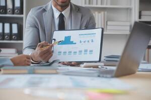 Finance manager meeting discussing company growth project success financial statistics, professional investor working start up project for strategy plan with document, laptop and digital tablet. photo