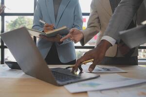 Finance manager meeting discussing company growth project success financial statistics, professional investor working start up project for strategy plan with document, laptop and digital tablet. photo