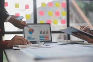 Finance manager meeting discussing company growth project success financial statistics, professional investor working start up project for strategy plan with document, laptop and digital tablet. photo