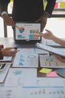 Finance manager meeting discussing company growth project success financial statistics, professional investor working start up project for strategy plan with document, laptop and digital tablet. photo