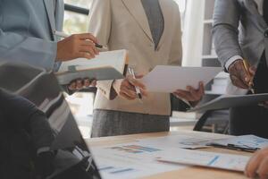Finance manager meeting discussing company growth project success financial statistics, professional investor working start up project for strategy plan with document, laptop and digital tablet. photo