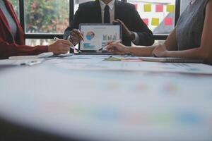 Finance manager meeting discussing company growth project success financial statistics, professional investor working start up project for strategy plan with document, laptop and digital tablet. photo