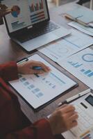 Finance manager meeting discussing company growth project success financial statistics, professional investor working start up project for strategy plan with document, laptop and digital tablet. photo