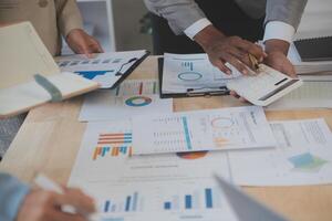 Finance manager meeting discussing company growth project success financial statistics, professional investor working start up project for strategy plan with document, laptop and digital tablet. photo