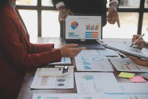 Finance manager meeting discussing company growth project success financial statistics, professional investor working start up project for strategy plan with document, laptop and digital tablet. photo