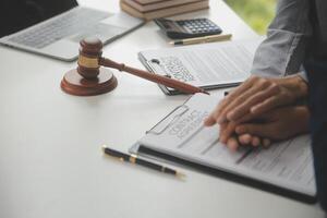 Lawyer, legal advisor, businessman brainstorming information on agreement details Business contracts in legal processing books for accuracy in contract documents. joint financial investment. photo