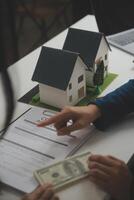 Business Signing a Contract Buy - sell house, insurance agent analyzing about home investment loan Real Estate concept. photo