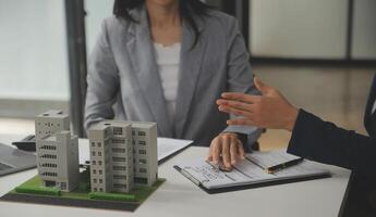 Business Signing a Contract Buy - sell house, insurance agent analyzing about home investment loan Real Estate concept. photo