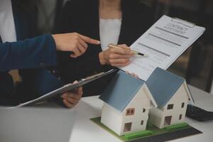 Business Signing a Contract Buy - sell house, insurance agent analyzing about home investment loan Real Estate concept. photo