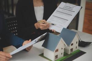 Business Signing a Contract Buy - sell house, insurance agent analyzing about home investment loan Real Estate concept. photo