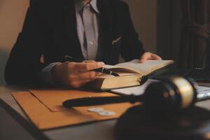 Business and lawyers discussing contract papers with brass scale on desk in office. Law, legal services, advice, justice and law concept picture with film grain effect photo