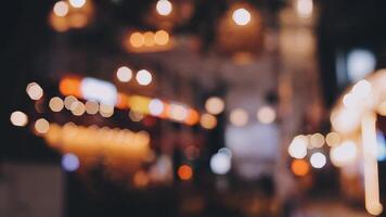 Beautiful bokeh in a dark blurry background at night on the walking street with the people. The round colorful bokeh shine from buildings and shops in the city lifestyle. Abstract concept. video