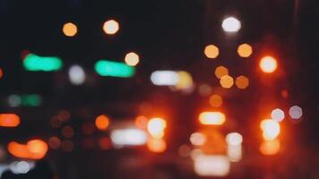 Beautiful bokeh in a dark blurry background at night on the walking street with the people. The round colorful bokeh shine from buildings and shops in the city lifestyle. Abstract concept. video