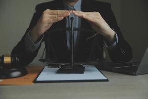 Business and lawyers discussing contract papers with brass scale on desk in office. Law, legal services, advice, justice and law concept picture with film grain effect photo