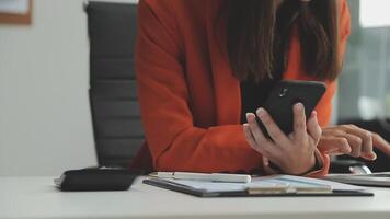 Young confident successful businesswoman using laptop and digital tablet, focused on work, creating business strategy plans on tablet. Female business professional distantly working online from home. video