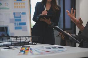 Close up ux developer and ui designer use augmented reality brainstorming about mobile app interface wireframe design on desk at modern office.Creative digital development agency photo