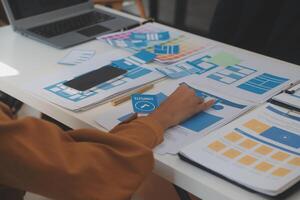 Close up ux developer and ui designer use augmented reality brainstorming about mobile app interface wireframe design on desk at modern office.Creative digital development agency photo