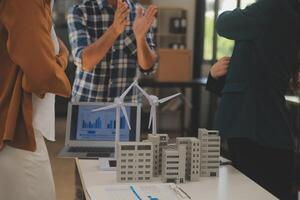 Electrical engineer with businessman discussing new project installation solar cell panel on the roof of building. Alternative energy concept. photo