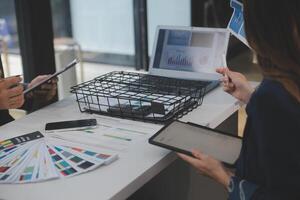 Close up ux developer and ui designer use augmented reality brainstorming about mobile app interface wireframe design on desk at modern office.Creative digital development agency photo