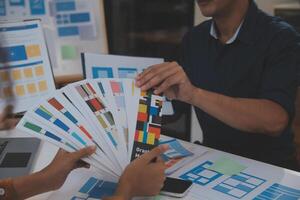 Close up ux developer and ui designer use augmented reality brainstorming about mobile app interface wireframe design on desk at modern office.Creative digital development agency photo