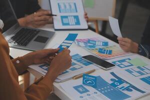 Close up ux developer and ui designer use augmented reality brainstorming about mobile app interface wireframe design on desk at modern office.Creative digital development agency photo