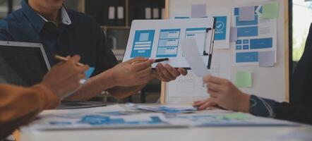 Close up ux developer and ui designer use augmented reality brainstorming about mobile app interface wireframe design on desk at modern office.Creative digital development agency photo