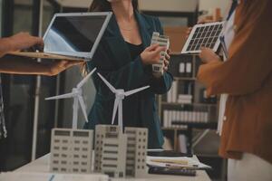 Electrical engineer with businessman discussing new project installation solar cell panel on the roof of building. Alternative energy concept. photo