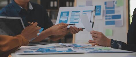 Close up ux developer and ui designer use augmented reality brainstorming about mobile app interface wireframe design on desk at modern office.Creative digital development agency photo