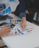 Close up ux developer and ui designer use augmented reality brainstorming about mobile app interface wireframe design on desk at modern office.Creative digital development agency photo