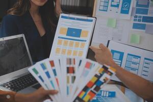 Close up ux developer and ui designer use augmented reality brainstorming about mobile app interface wireframe design on desk at modern office.Creative digital development agency photo