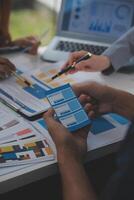 Close up ux developer and ui designer use augmented reality brainstorming about mobile app interface wireframe design on desk at modern office.Creative digital development agency photo