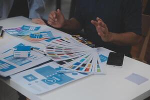 Close up ux developer and ui designer use augmented reality brainstorming about mobile app interface wireframe design on desk at modern office.Creative digital development agency photo