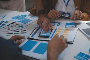 Close up ux developer and ui designer use augmented reality brainstorming about mobile app interface wireframe design on desk at modern office.Creative digital development agency photo