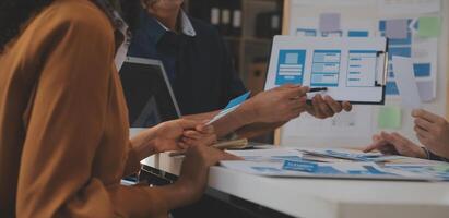 Close up ux developer and ui designer use augmented reality brainstorming about mobile app interface wireframe design on desk at modern office.Creative digital development agency photo