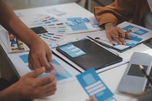 Close up ux developer and ui designer use augmented reality brainstorming about mobile app interface wireframe design on desk at modern office.Creative digital development agency photo