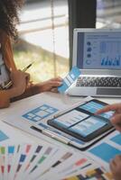 Close up ux developer and ui designer use augmented reality brainstorming about mobile app interface wireframe design on desk at modern office.Creative digital development agency photo