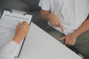 Male diseases. Man presses hands to his groin and suffering from pain, panorama, cropped, studio shot photo