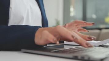 Woman working at home office hand on keyboard close up video