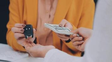 Insurance officers hand over the car keys after the tenant. have signed an auto insurance document or a lease or agreement document Buying or selling a new or used car with a car video